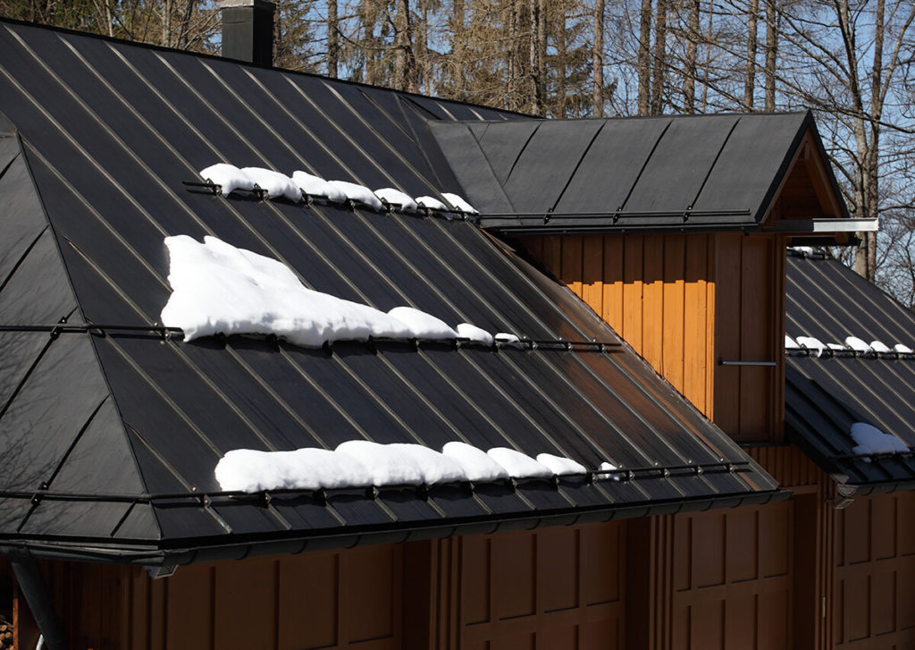 Metal roof of house with snow