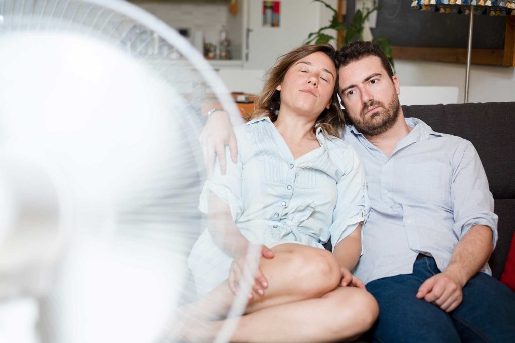 a-couple-struggling-with-ventilation-and-air-conditioning
