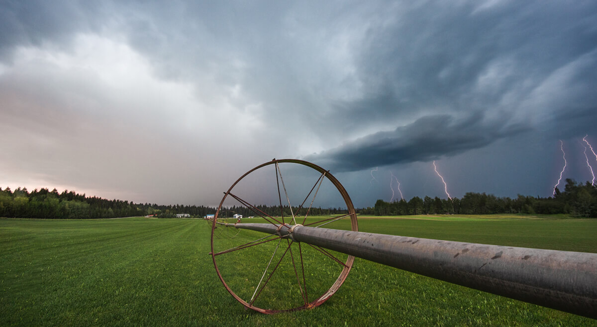 lightning storm passing over a green field