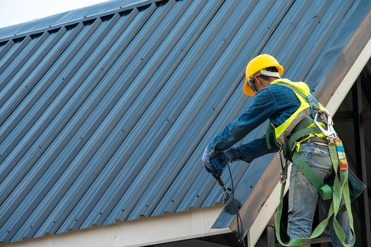 Construction worker wearing safety harness belt